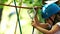 Rope adventure - a little girl and her mother moving over the rope bridge