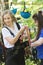 Rope adventure - a woman instructor puts on the insurance pendants on the waist of young woman