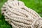 Rope closeup on green grass. jute fibers