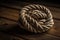 Rope coiled into ball on wooden background. Generative AI