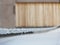 A rope covered with hoarfrost on the background of a wooden barn