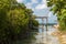 Rope hammocks suspended above lagoon water on tropical island vacation paradise for relaxing.