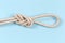 Rope knot Ð°igure-eight loop on blue background, close-up