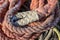 A rope lying on the wharf in the port. Fishing accessories in the port