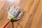 rope mop is wiping wooden laminate floor at home