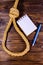 Rope with noose for the suicide, blank notepad and pen on wooden background