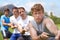 Rope, pull and men portrait with strong teamwork, tug of war and fitness outdoor on sport field. Training, workout and