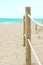 Rope Railing with Wooden Poles on the Beach. Fine White Sand Turquoise Sea Blue Sky. Vacation Relaxation Serenity Tranquility