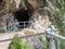 Rope and shackles anchored in hard dolomite limestone rock. Climbers path via ferrata