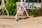 Rope swing suspended on a tree branch background rest sandy ground