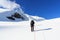 Rope team mountaineering with crampons on glacier Taschachferner towards Wildspitze and mountain snow panorama with blue sky in