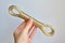 Rope tied in a loop on a white background in a woman`s hand, concept against suicide