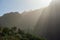 Roque Nublo, symbolic natural monument of Gran Canaria in backlight sunset evening light covered in Sahara desert sand storm.