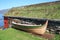 Rorbu with grass on the roof and old boat