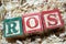 ROS return on sales acronym on wooden blocks