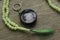 Rosary beads and compass on wooden background