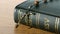 Rosary beads falling onto bible on a table