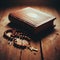 Rosary beads lay poignantly across a leather bound book of faith, on old wooden surface