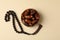 Rosary and bowl with dates on beige background