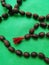 Rosary from a lotus on a green background.