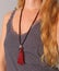 Rosary mala 108 beads from natural stones Garnet are worn on a girl in a grey shirt. Author`s jewelry from natural stones,