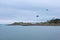 Roscoff, Brittany, houses at the coast, clouded sky, seagulls flying in the sky