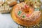 Roscon de reyes with cream and christmas ornaments. Kings day concept spanish three kings cake