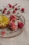 Rose and chrysanthemum flowers in a glass bowl