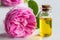 Rose essential oil: a bottle of oil with a rose flower