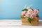 Rose flower bouquet on old books over wooden background