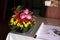 Rose flowers, candles, wood pieces and other small decoration on reception table for wedding party in catholic church