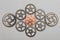 Rose-gold cogwheel and bunch of silver cogwheels