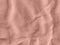 Rose gold color velvet fabric texture top view. Female blog pink velour background. Smooth soft velvety cloth metallic
