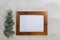 Rose gold frame mockup and eucalyptus on gray wash background flat lay copy space