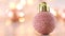 Rose gold glitter Christmas ornament with blinking lights on light theme