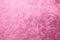 Rose gold pink velvet background or velour flannel texture made of cotton or wool with soft fluffy velvety satin fabric cloth meta