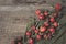 Rose hip berries, sweet briar fruits, gloves on wooden board