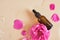 Rose hip oil concept. Brown glass dropper bottle and dog rose hip flower