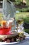 Rose petals float in pink water in a glass spherical vase, white and yellow sand in glasses, two glasses with champagne, decor