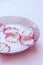 Rose petals in milk. Milk with petals in a plate