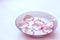 Rose petals in milk. Milk with petals in a plate