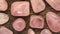 Rose quartz rare jewel on black wood texture. Scarce mineral pebbles background. Moving right seamless loop backdrop