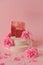 Rose soap. Beauty and aromatherapy. Flower soap. Pink soap bars and pink roses on pink background. Soap with Rose