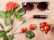 Rose, sunglasses, lipstick and a strawberry