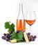 Rose wine bottle, corkscrew, wineglass and grapes.