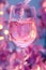 Rose wine pouring in glass, holographic, glowing neon lights color aesthetics. Drops and splashes of liquid around the wineglass.