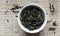 Rosebay willowherb fermented green tea in a white bowl on woven grey cotton fabric, closeup, traditional russian drink,