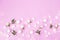 Rosebuds, petals, candles, on a pink background. Concept for a greeting card. Weddings, Valentine`s Day, Birthday