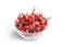 Rosehip berries in a glass bowl on a light background