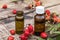Rosehip essential oil on a wooden table near ripe red rosehip berries. Tincture or essential oil with rose hips